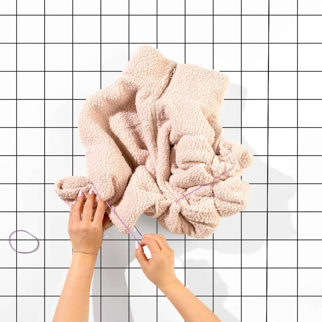 Zgniatanie kurtki oraz zabezpieczanie jej gumkami receptrukami